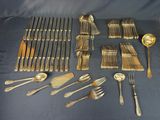 many different types of silverware on the table