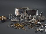 a lot of silver and silverware on a table