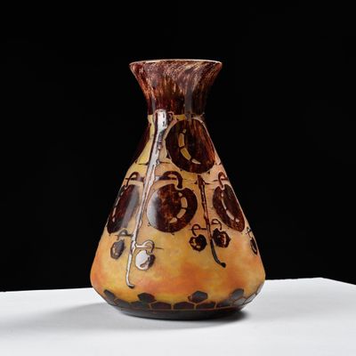 a vase that is sitting on a table with a black background