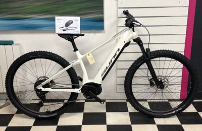 a bike that is sitting in a room with a checkered floor
