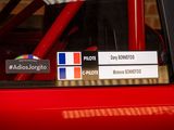 a red car with stickers on the side of it