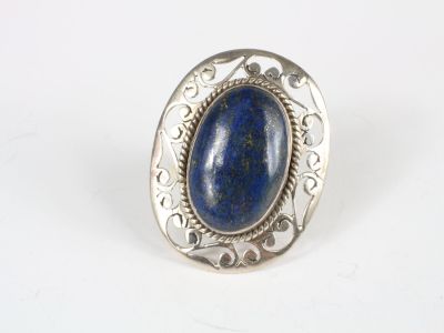 a close up of a silver ring with a blue stone in it
