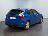 the rear end of a blue car parked in a garage
