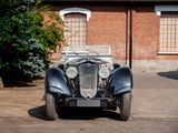 a vintage car parked in front of a brick building