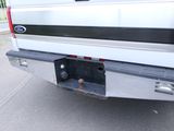 a white truck with a black stripe on the back of it