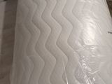 a mattress that has been wrapped in plastic on the floor