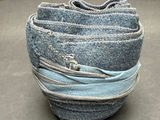 a stack of blue jeans stacked on top of each other