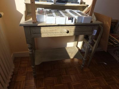 a small desk with a lot of books on it