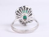 an image of a ring with a green stone in the center