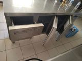 a stainless steel counter top with a drawer in it