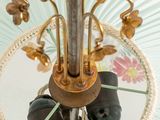 a glass umbrella with a flower design on it