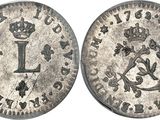 a silver coin with the letter l on it