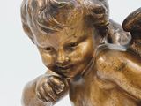 a statue of an angel holding a baby in his arms