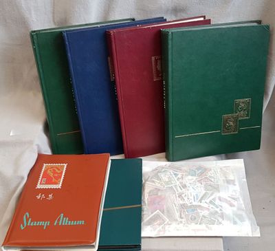 several different colored books are lined up on a white surface