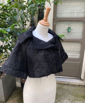 a close up of a mannequin with a black jacket on it
