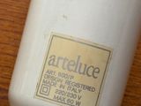 a bottle of lotion sitting on a wooden table