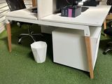 a desk with two computers and a chair in the room