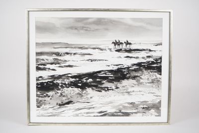 black and white photograph of two people riding horses in the ocean