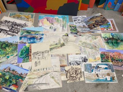 a lot of paintings that are on the floor