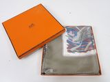 an orange box with a white and blue scarf inside of it
