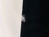 a bullet hole in the side of a white wall