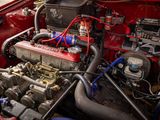 a red car with an engine in it ' s trunk