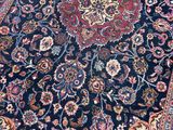 a close up of a blue rug with a medallion design on it