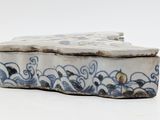 a blue and white box sitting on a white surface