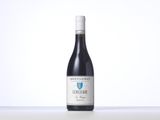 a bottle of red wine sitting on top of a table