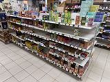 many shelves in the store that have various types of food on them