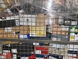 a metal cage filled with assorted items in a warehouse