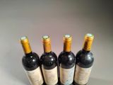 three bottles of wine sitting on top of a table next to each other