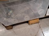 a plastic container that is sitting on a pallet on the floor