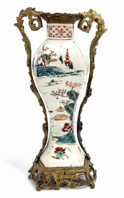 a vase that is sitting on a stand on a white surface