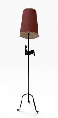 an image of a lamp that is on a stand with a red shade