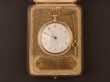 a gold pocket watch with a chain hanging from it