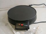 an image of a crepe maker on a counter top