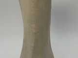 a white vase with a black handle sitting on a table