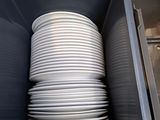 a stack of white plates in a plastic container