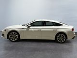 the white car is parked on the concrete floor in the room