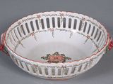 a white bowl with red flowers on it on a gray surface