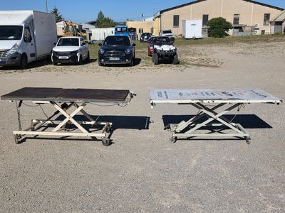 two tables sitting in the middle of a parking lot