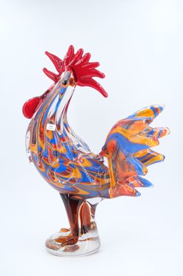 a colorful rooster figurine on a white background
