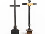 two wooden crosses are standing next to each other in a room