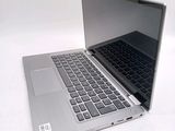 a silver laptop with a black keyboard on a white surface
