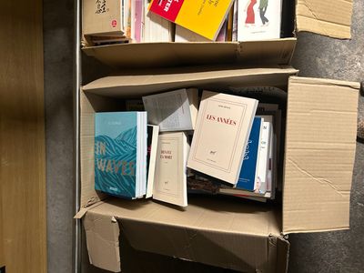 boxes of books are stacked on top of each other in a room