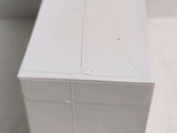 a white box sitting on the floor next to a toilet