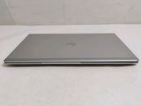 the laptop is sitting on a white surface with a white background