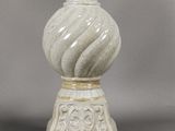a white vase with a decorative design on it