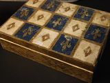 a wooden box with a blue and gold design on it